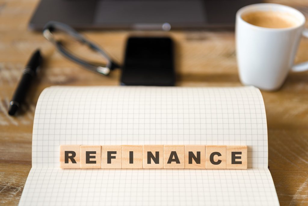 Refinance written in scrabble tiles on a desk